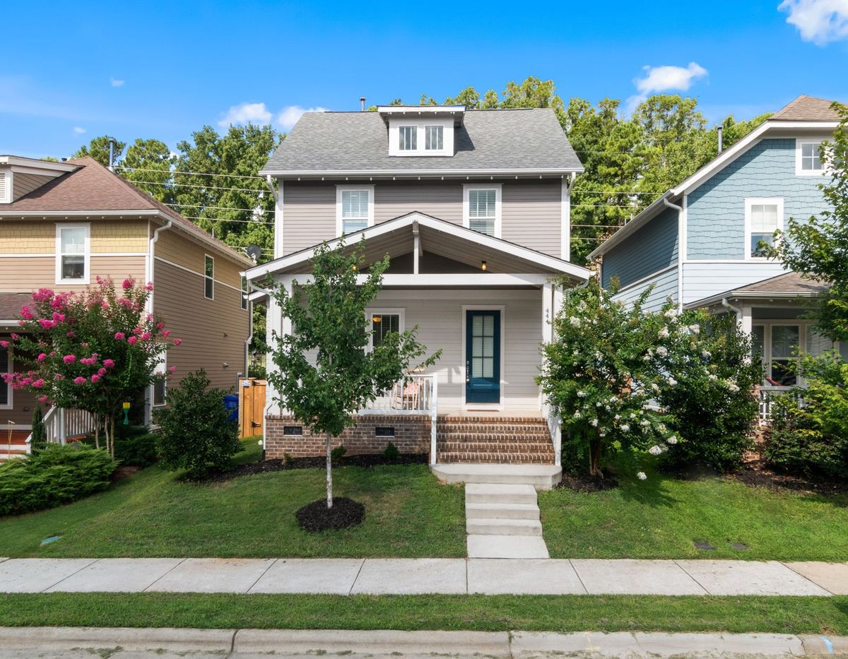 Bright front walkway leading to the porch of a craftsman home